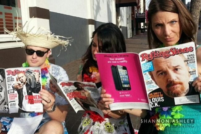 3 people in Hawaiian dress reading Rolling Stone Magazine