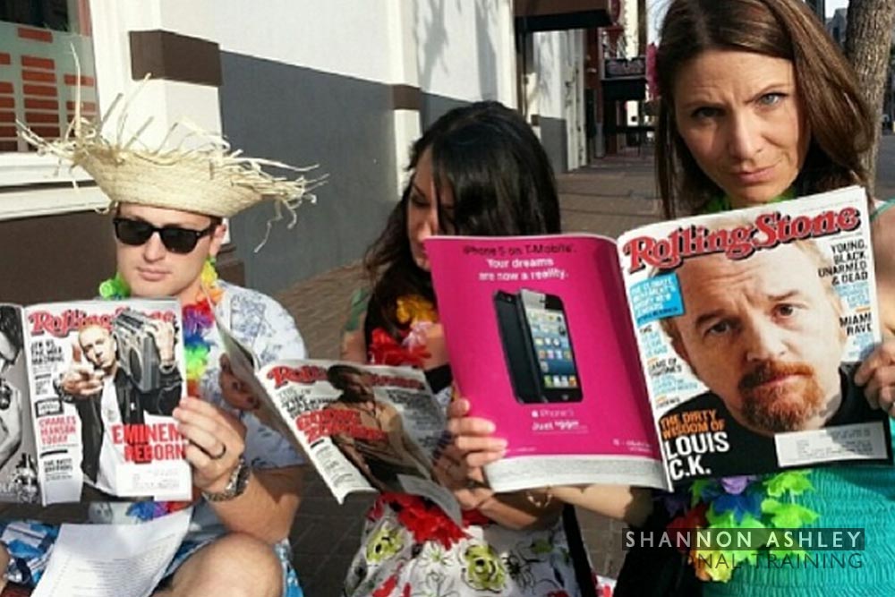 3 people in Hawaiian dress reading Rolling Stone Magazine
