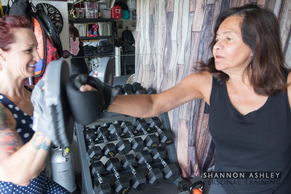 Woman boxing with Shannon Ashley.